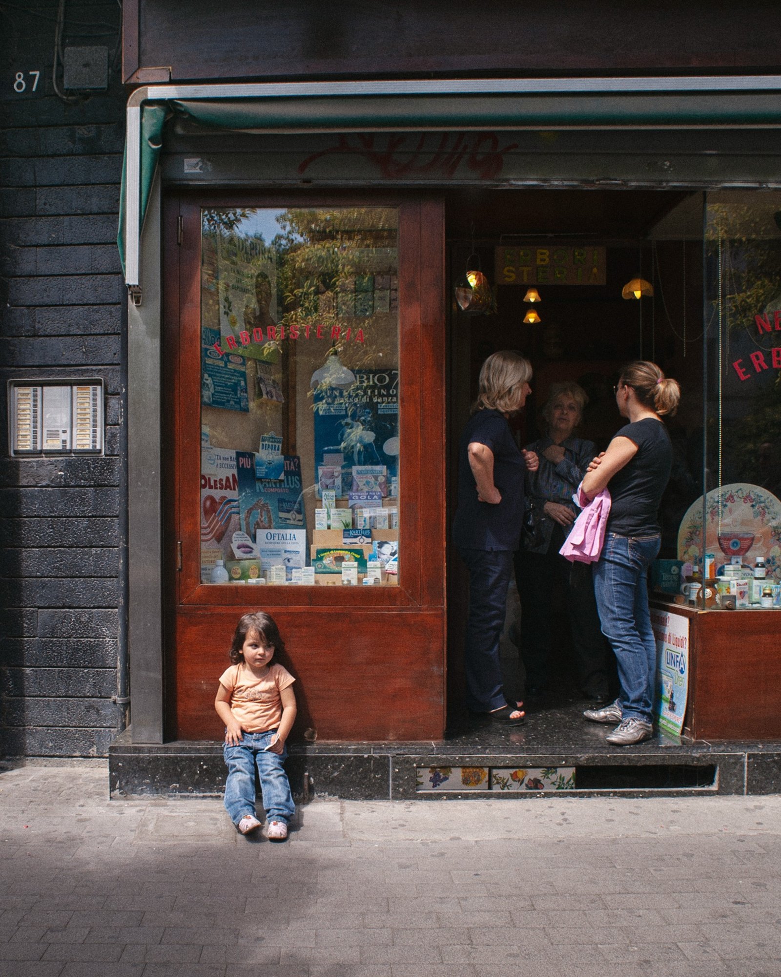 Child outside storefront